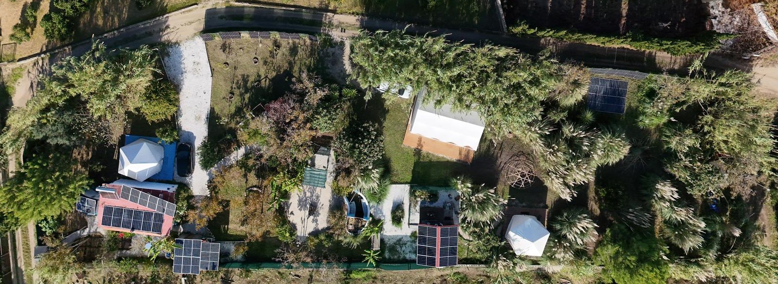 Overhead drone view of Tao showing paths, planting, structures, and the shape of the land