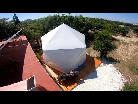Early Tao build with a white garden structure and open gravel ground